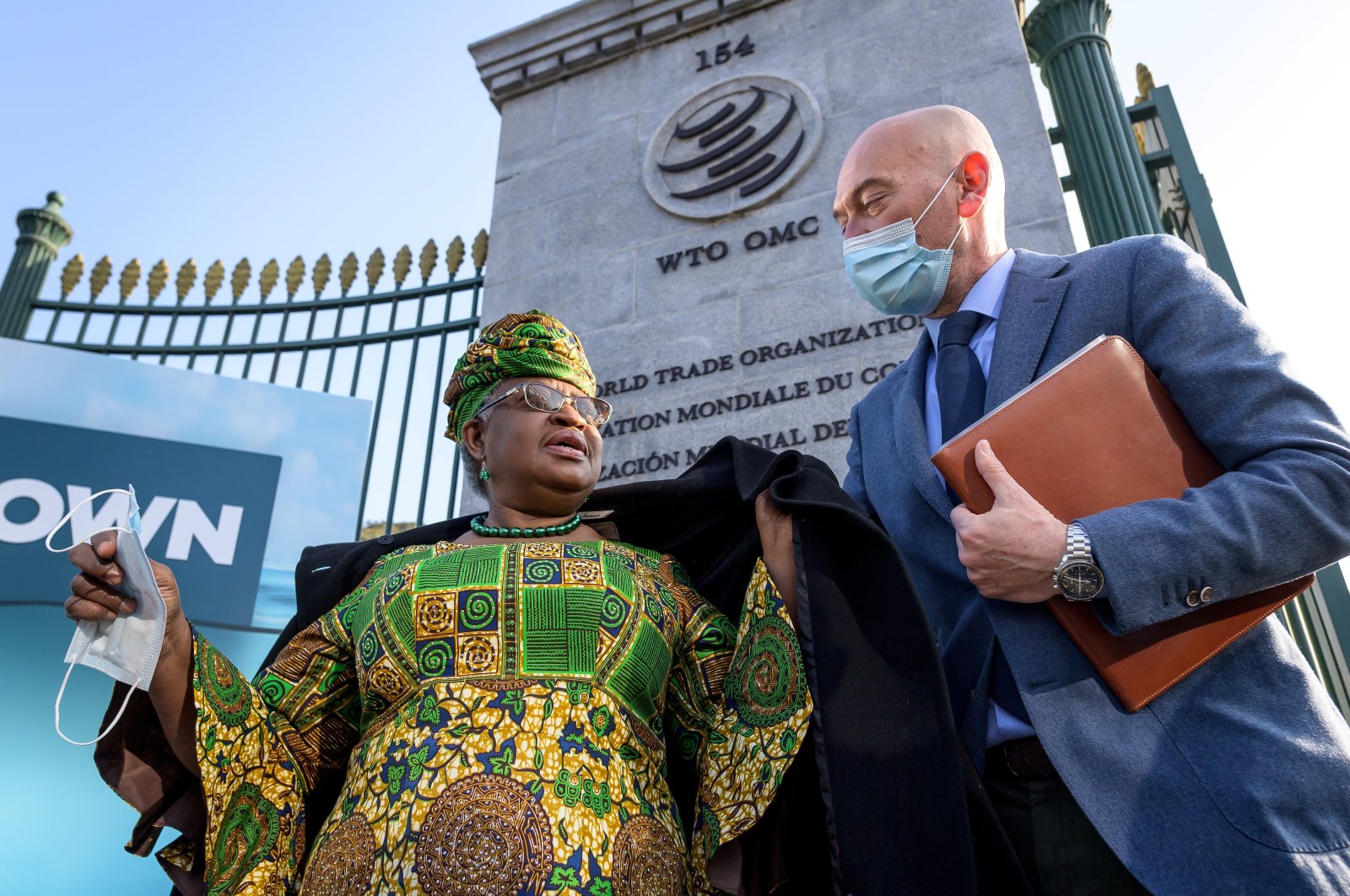 New Director-General of the World Trade Organisation Ngozi Okonjo-Iweala (L) walks at the entrance of the WTO following a photo-op upon her arrival at the WTO headquarters to take office in Geneva, Switzerland, March 1, 2021. (Reuters Photo)