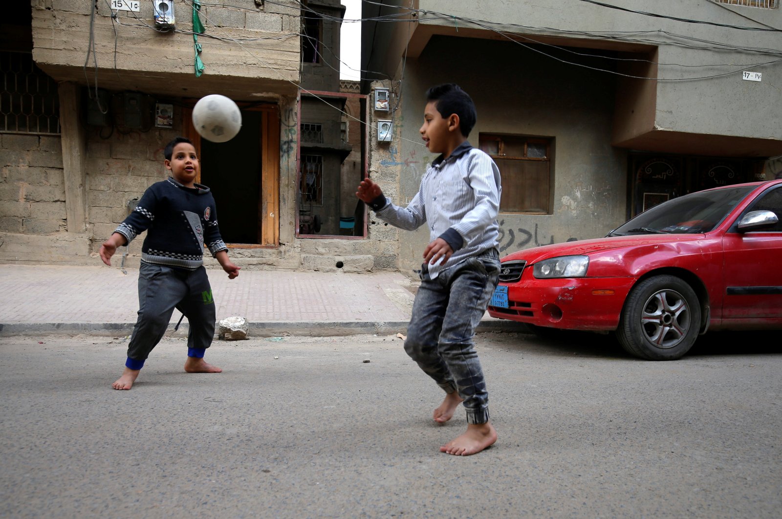 Boys play football outside their house in Sanaa, Yemen, Feb. 27, 2021. (Reuters Photo)