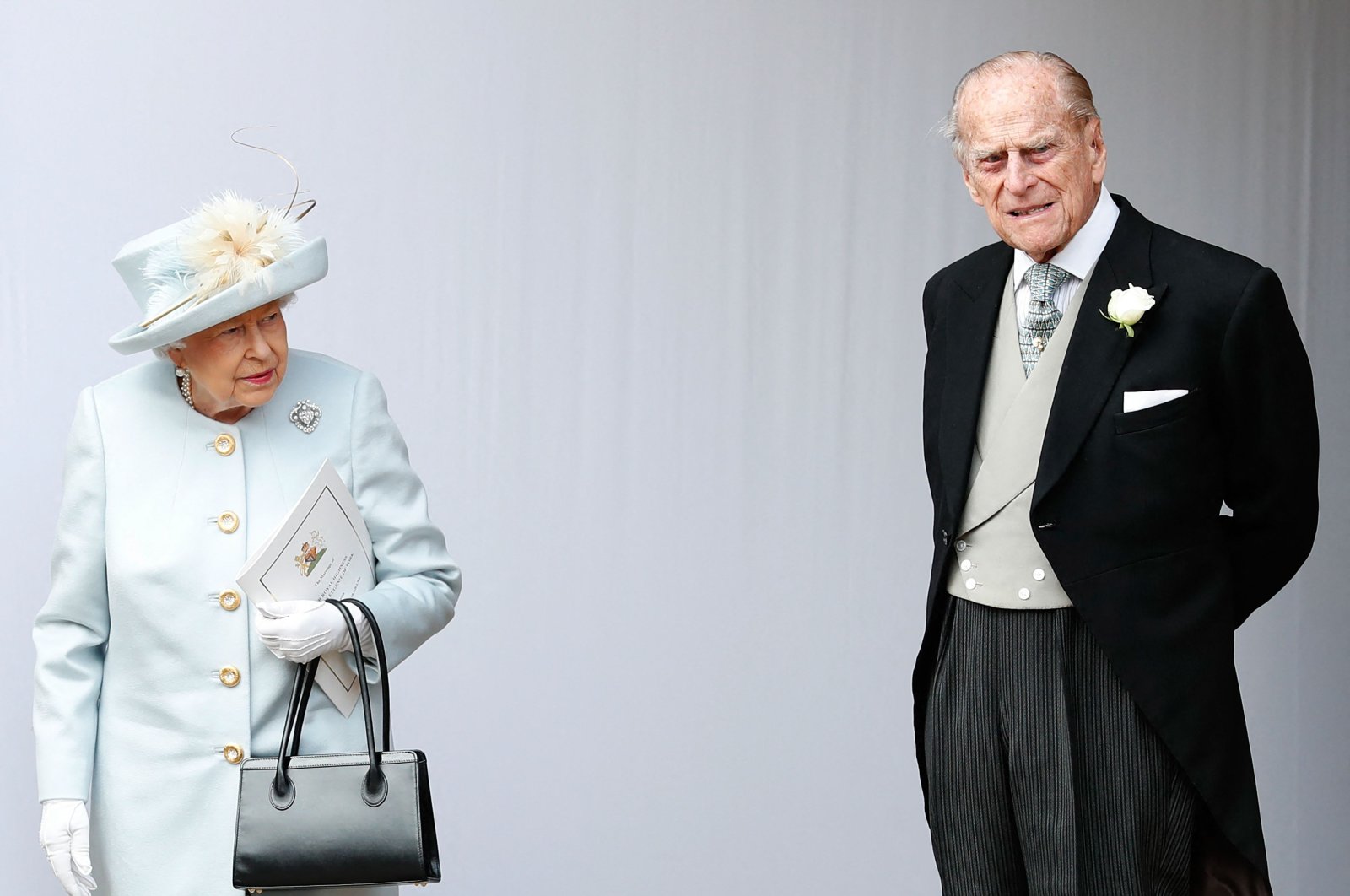 Britain's Queen Elizabeth II (L) and her husband Prince Philip, Duke of Edinburgh (R), wait for the carriage carrying Princess Eugenie of York and her husband, Jack Brooksbank, in Windsor, U.K., Oct. 12, 2018. (AFP Photo)