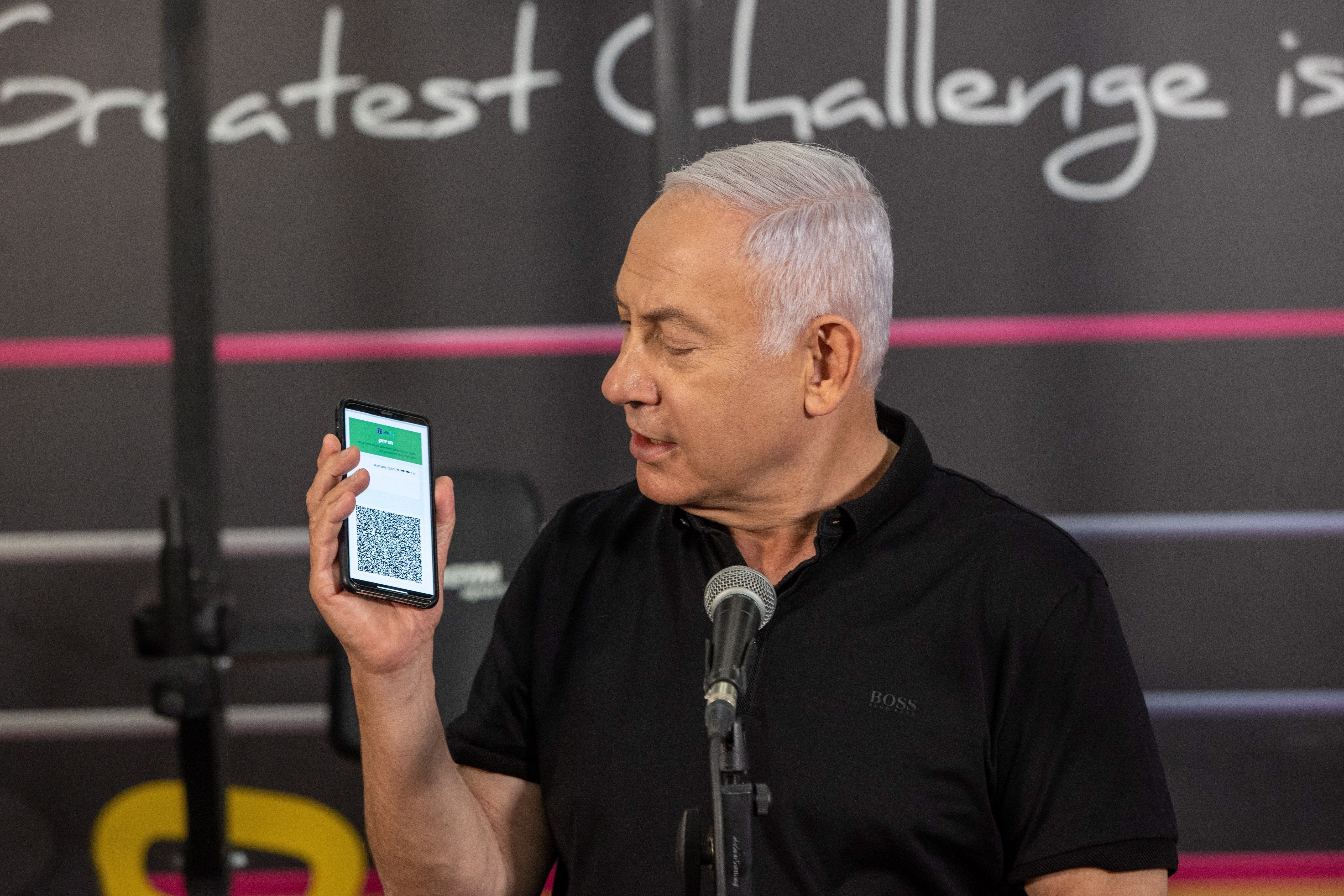 Israeli Prime Minister Benjamin Netanyahu holds a phone as he speaks during a visit to a fitness gym ahead of the reopening of gyms, in Petah Tikva, Israel, Feb. 20, 2021.  (EPA Photo)