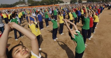 Indian schoolchildren perform Surya Namaskar during a function to mark the 150th birth anniversary of Swami Vivekananda, in New Delhi, India, Feb. 18, 2013. (AP Photo)