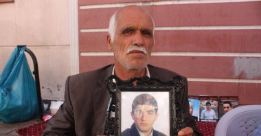 Şehmus Kaya holds a picture of his son Vedat during a sit-in protest against the PKK in southeastern Diyarbakır province, Turkey, Oct. 22, 2019. (İHA Photo)