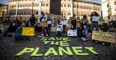 Protesters carry placards at the Fridays for Future Italia initiative in Montecitorio square in Rome, Italy, Feb. 19, 2021. (EPA)