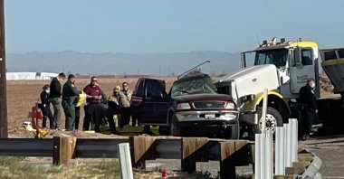 In this image from KYMA law enforcement work at the scene of a deadly crash involving a semitruck and an SUV in Holtville, Calif., on Tuesday, March 2, 2021. (KYMA via AP)