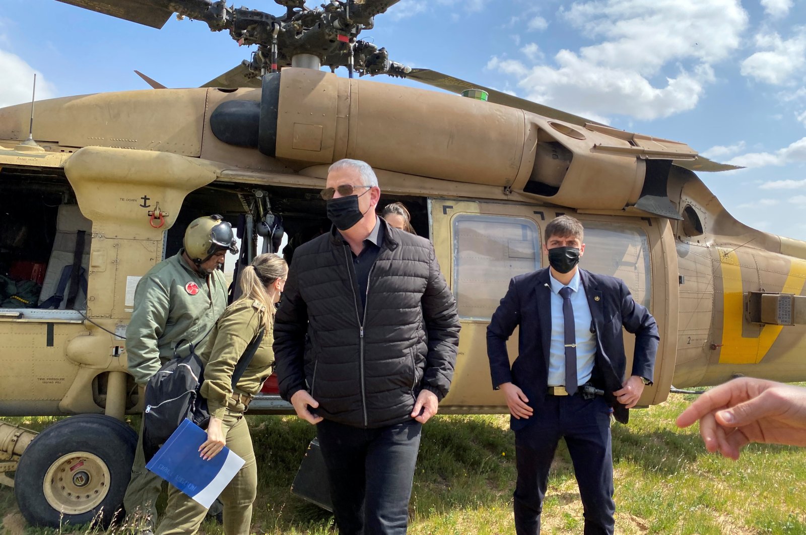 Israeli Defense Minister Benny Gantz adjusts his jacket after stepping off a helicopter during a tour of the Gaza border area, in southern Israel, March 2, 2021. (Reuters Photo)
