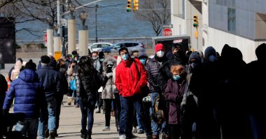 People wait in a line stretching around the Jacob K. Javits Convention Center on midtown Manhattan's west side, to receive a coronavirus vaccine at the site which has been converted into a mass vaccination center in New York City, New York, U.S., March 2, 2021. (Reuters Photo)