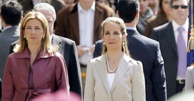 Spain's Princess Cristina (L) and Princess Elena, listen to the Spanish national anthem during a ceremony upon their arrival for the opening of the Spanish Parliament, April 16, 2008. (AP Photo)