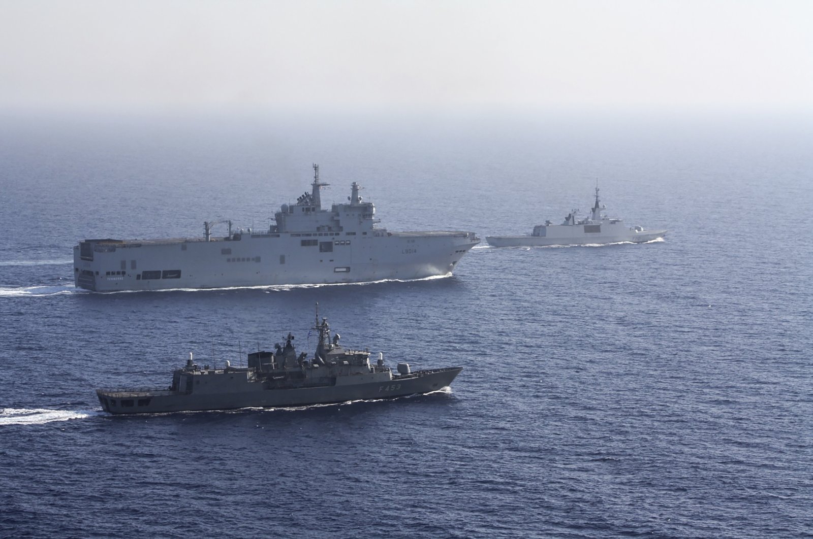 In this photo provided by the Greek Ministry of National Defense, a French Tonnerre helicopter carrier (rear L) is escorted by Greek and French military vessels during a maritime exercise in the Eastern Mediterranean, Aug. 13, 2020. (AP Photo)