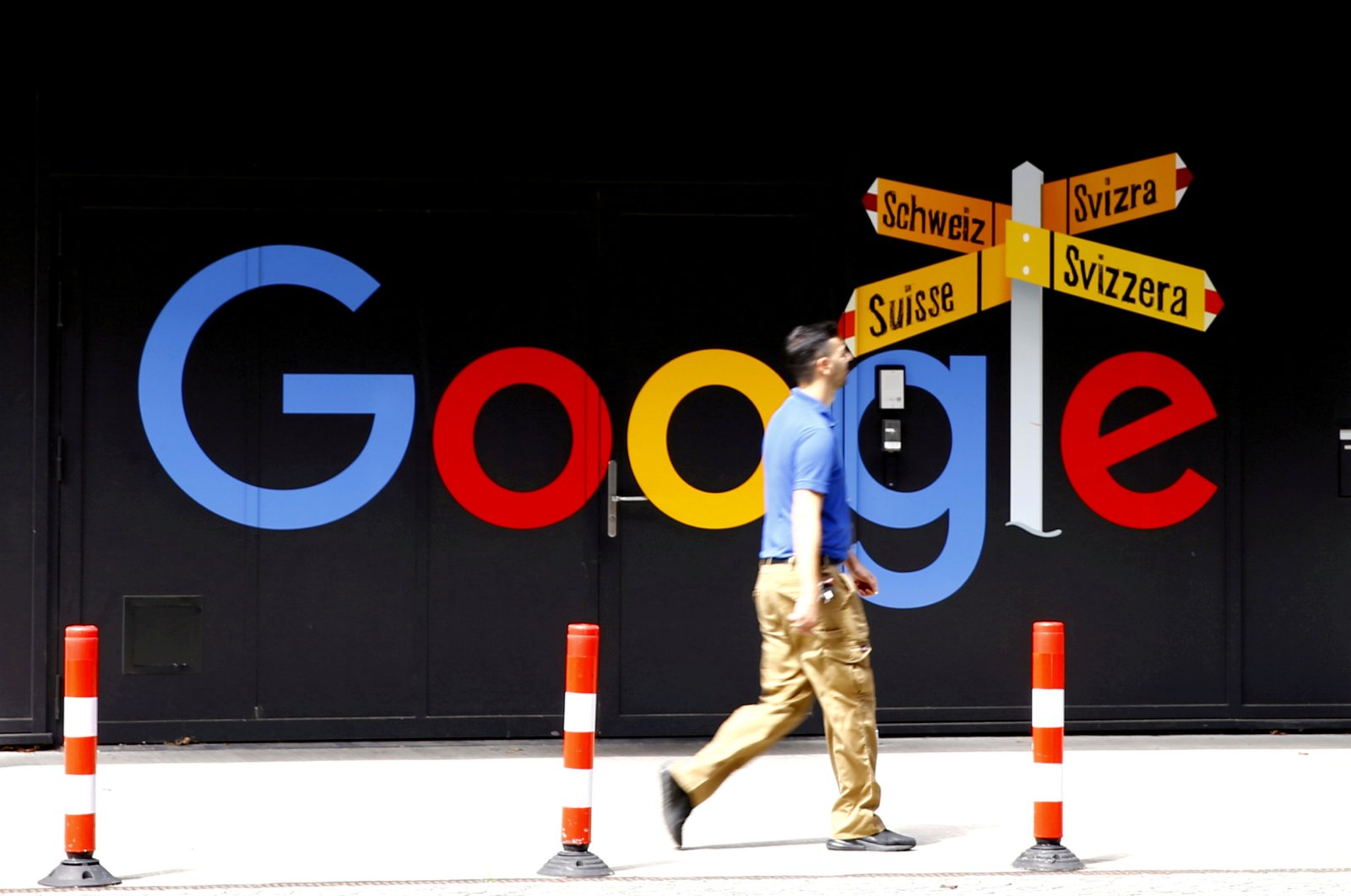 A man walks past a logo of Google in front of at an office building in Zurich, Switzerland, July 1, 2020. (Reuters Photo)