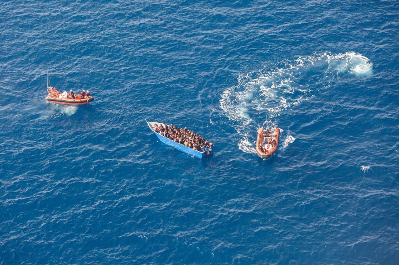 Members of the German charity Sea-Watch 3 rescue ship team help migrants on a wood boat during a rescue operation in the Mediterranean Sea, Feb. 26, 2021. (Reuters Photo)
