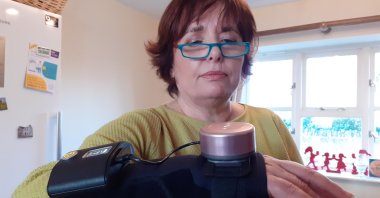 Business analyst Jenny Field wears a glove with a built-in spinning gyroscope that helps people with Parkinson's disease and essential tremor stop their hands from shaking, at her home near Towcester, Britain, Dec. 15, 2020. (REUTERS Photo)