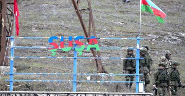 Russian peacekeepers and Azerbaijani servicepeople patrol the area at the entrance to the town of Shusha, Azerbaijan, Nov. 26, 2020. (Photo by Getty Images)