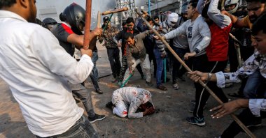 A group of men chanting pro-Hindu slogans beats Mohammad Zubair (C), 37, who is Muslim, during protests sparked by a new citizenship law in New Delhi, India, Feb. 24, 2020. (Reuters Photo)