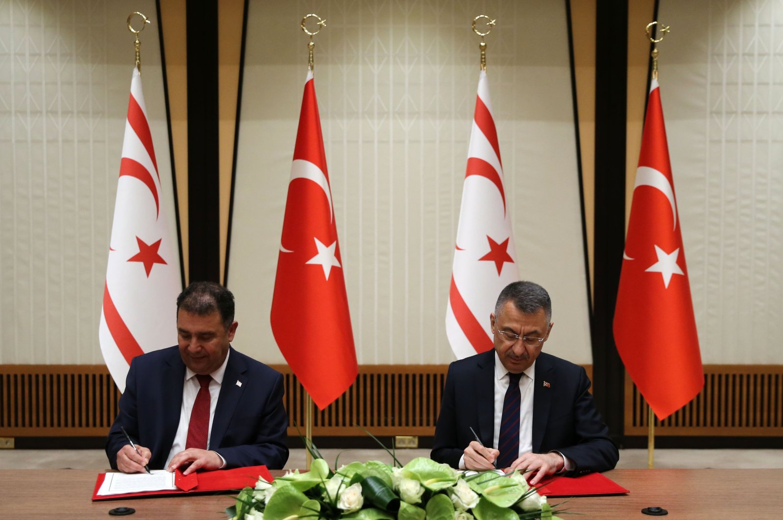 Turkish Republic of Northern Cyprus (TRNC) Prime Minister Ersan Saner (L) and Turkish Vice President Fuat Oktay sign the Turkey-TRNC 2021 Economic and Monetary Cooperation Agreement, Ankara, Turkey, March 4, 2021. (AA Photo)