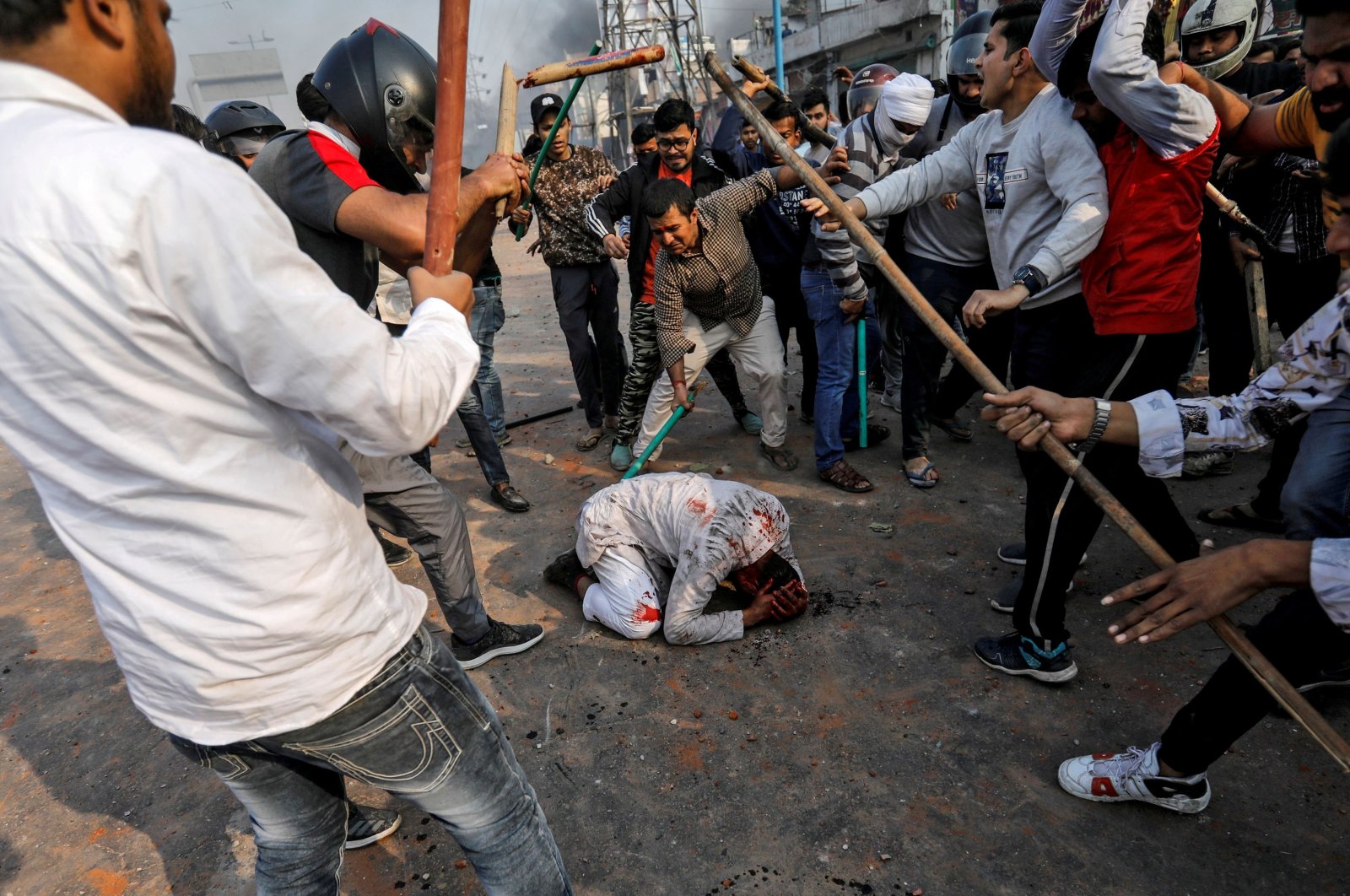 A group of men chanting pro-Hindu slogans beats Mohammad Zubair (C), 37, who is Muslim, during protests sparked by a new citizenship law in New Delhi, India, Feb. 24, 2020. (Reuters Photo)
