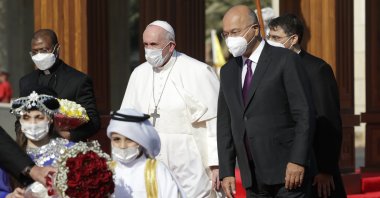 Pope Francis is welcomed by Iraqi President Barham Salih, at Baghdad's Presidential Palace, Iraq, Friday, March 5, 2021. (AP Photo)