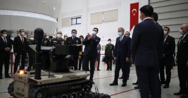 National Defense Minister Hulusi Akar examines products, including an unmanned ground vehicle (UGV) during a visit to Havelsan, Ankara, Turkey, Feb. 27, 2021. (DHA Photo)