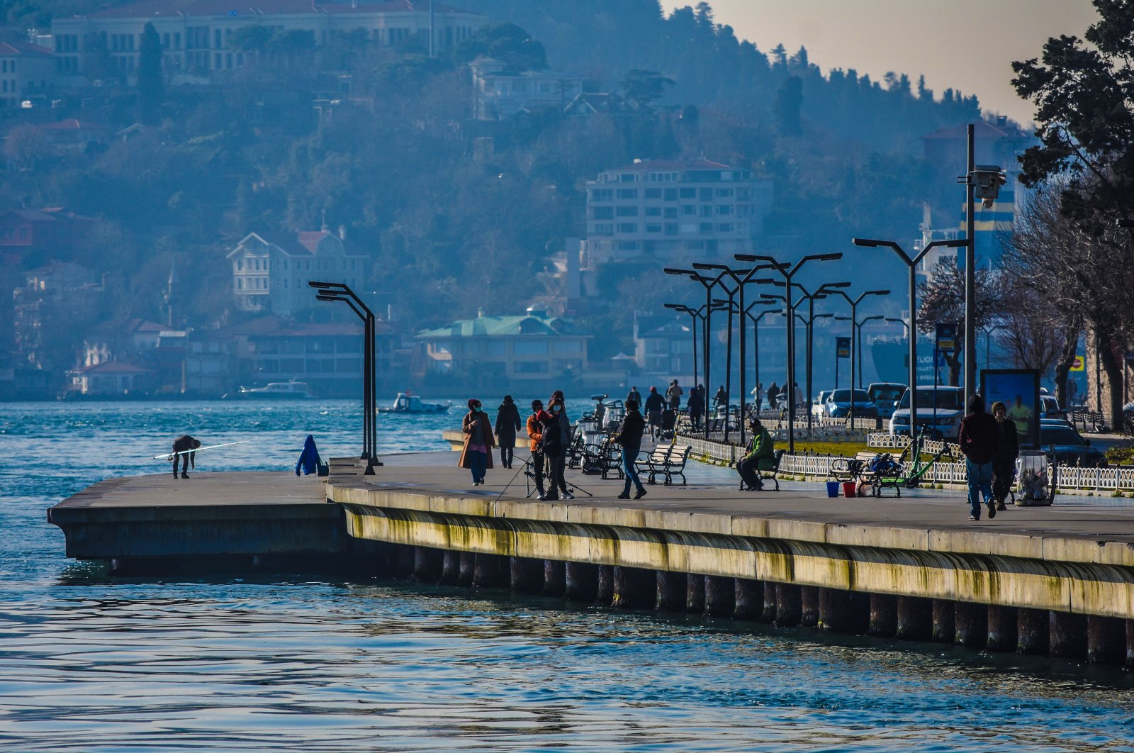 People enjoy sunny weather on a coastline in the Sarıyer district, Istanbul, Turkey, March 3, 2021. (Photo by Getty Images)