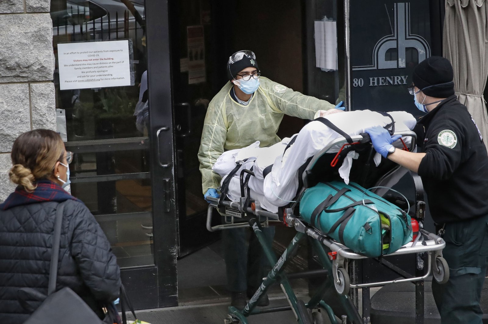 A patient is wheeled into Cobble Hill Health Center by emergency medical workers, in the Brooklyn borough of New York City, New York, U.S., on April 17, 2020. (AP Photo)