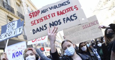 Protesters hold placards reading "stop sexist and racist violence in our high schools" during a demonstration called by Feminist Strike Movement for Women's Rights Day, on March 6, 2021. (AFP Photo)
