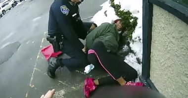 This image taken body camera video released by the Rochester, N.Y., Police Department on Friday, March 5, 2021, shows an officer struggling to subdue a woman suspected of shoplifting who tried to escape with her 3-year-old child in her arms on Feb. 22, 2021.  (Rochester Police Department via AP)