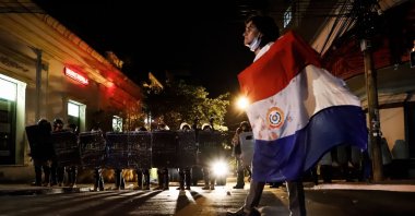 Police officers advance to disperse protesters during a demonstration against the government and President Mario Abdo Benitez for his management of the coronavirus pandemic, in Asuncion, Paraguay, March 5, 2021. (EPA Photo)