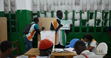 Workers of the Independent Electoral Commission (IEC) count the number of voters after the closure of the polling stations during the legislative elections, in Abidjan, on March 6, 2021. (AFP Photo)