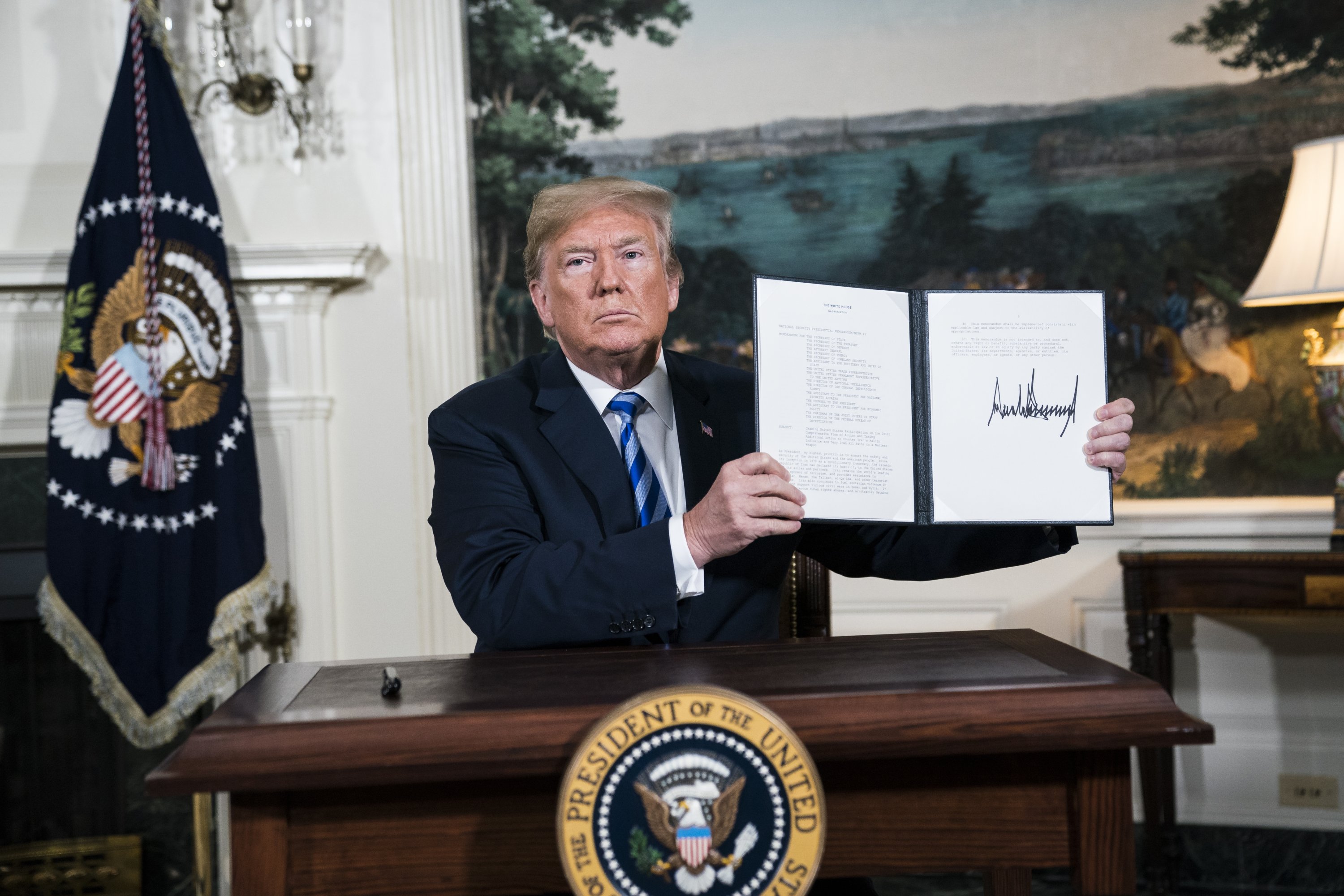 Then-U.S. President Donald Trump signs a presidential memorandum as he announces the U.S. withdrawal from the Iranian nuclear deal, at the White House, Washington, D.C., U.S., May 8, 2018. (Photo by Getty Images)