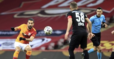 Galatasaray's Arda Turan (L) shoots as Sivasspor's Ziya Erdal (R) looks on during a Turkish Süper Lig match at the Türk Telekom Stadium, Istanbul, Turkey, March 8, 2021. (AA Photo)