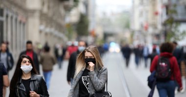 Two women walk on Istiklal Avenue wearing masks to protect against COVID-19, in Istanbul, Turkey, May 8, 2020. (AA Photo)