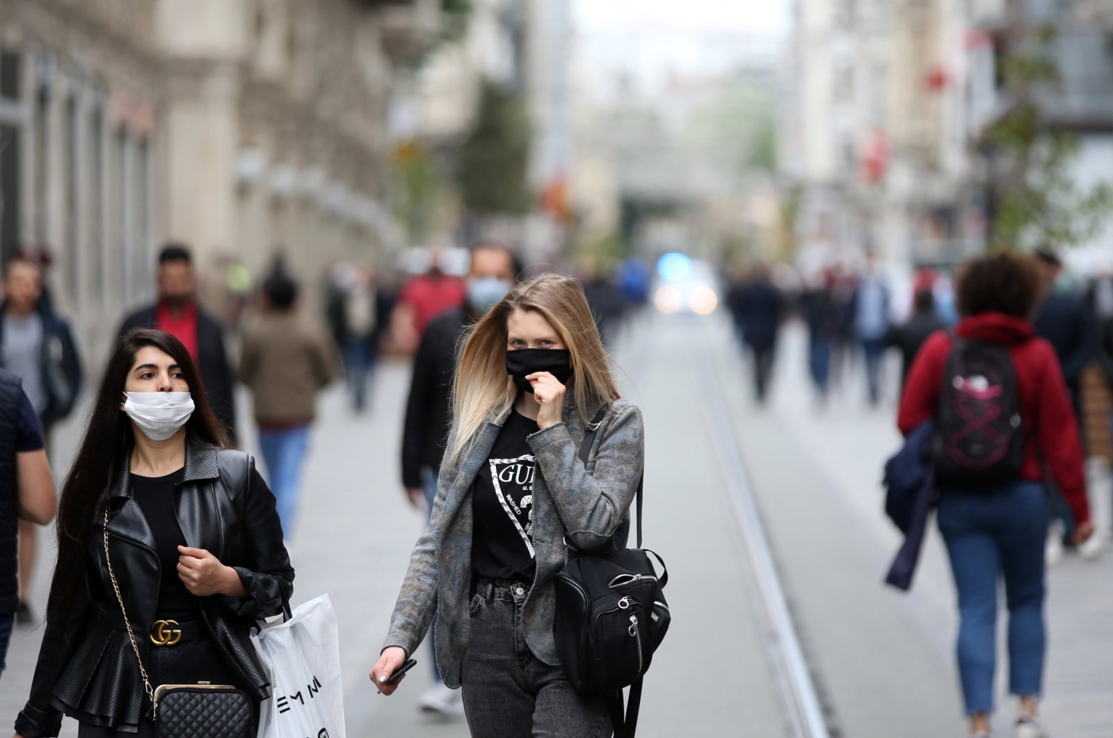 Two women walk on Istiklal Avenue wearing masks to protect against COVID-19, in Istanbul, Turkey, May 8, 2020. (AA Photo)