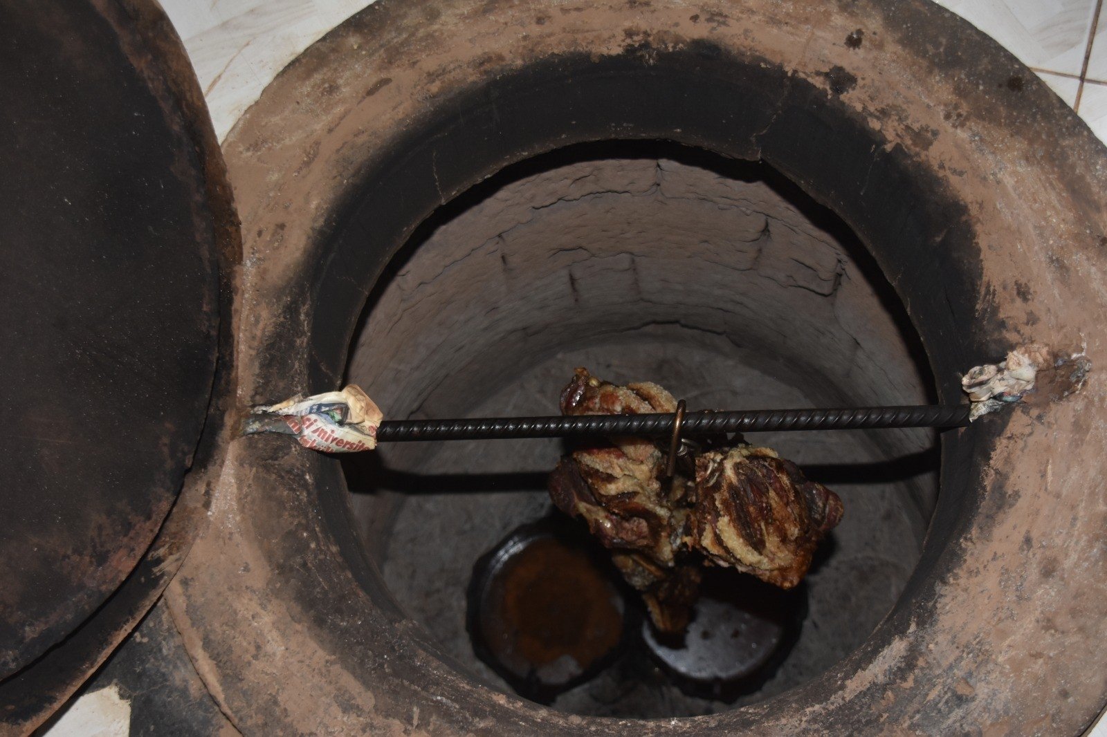 The goat meat for büryan kebab is cooked in a well for hours on end. (IHA Photo)