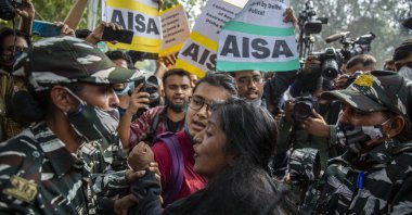 Paramilitary soldiers try to stop students protesting against the police action against various activists in New Delhi, India, Feb. 16, 2021. (AP Photo)
