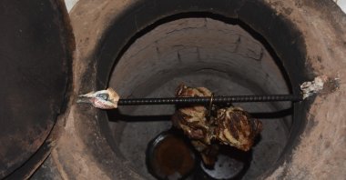 The goat meat for büryan kebab is cooked in a well for hours on end. (IHA Photo)