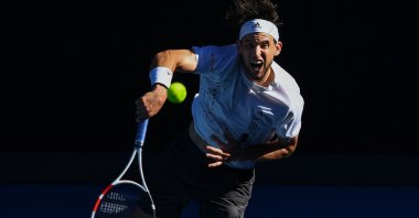 Austria's Dominic Thiem serves against Bulgaria's Grigor Dimitrov during their Australian Open men's singles match in Melbourne, Australia, Feb. 14, 2021. (AFP Photo)