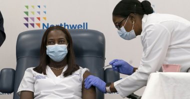 In this Dec. 14, 2020, file photo, Sandra Lindsay (L), a nurse at Long Island Jewish Medical Center, is inoculated with the Pfizer-BioNTech COVID-19 vaccine by Dr. Michelle Chester, in the Queens borough of New York. (AP Photo)