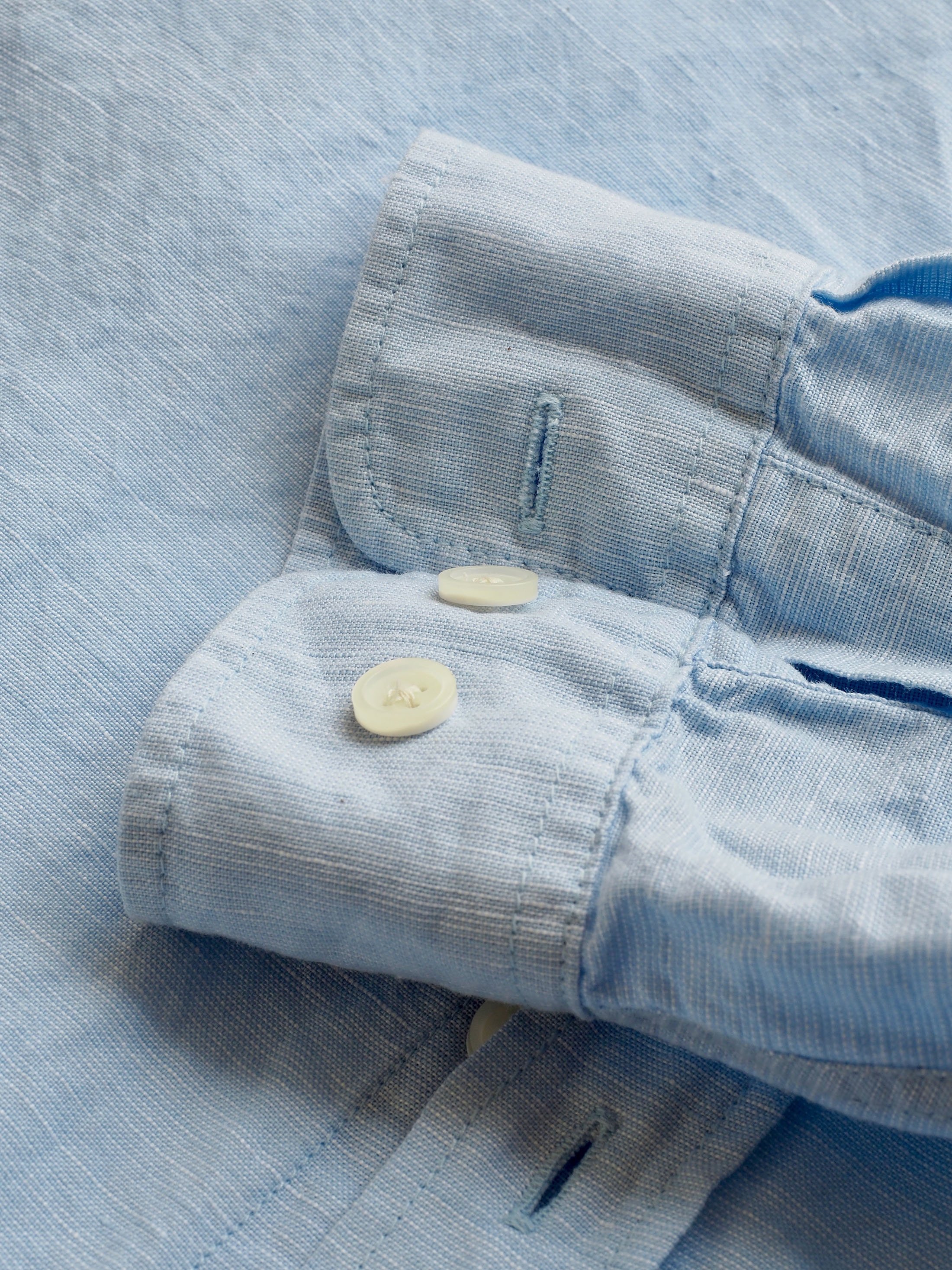 A white or blue linen shirt is a summer wardrobe staple. (Shutterstock Photo)