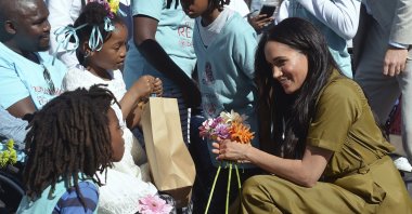 Meghan, the Duchess of Sussex, talks to children during a walkabout in Bo-Kaap, a heritage site, in Cape Town, South Africa, Sept, 24, 2019. (AP Photo)