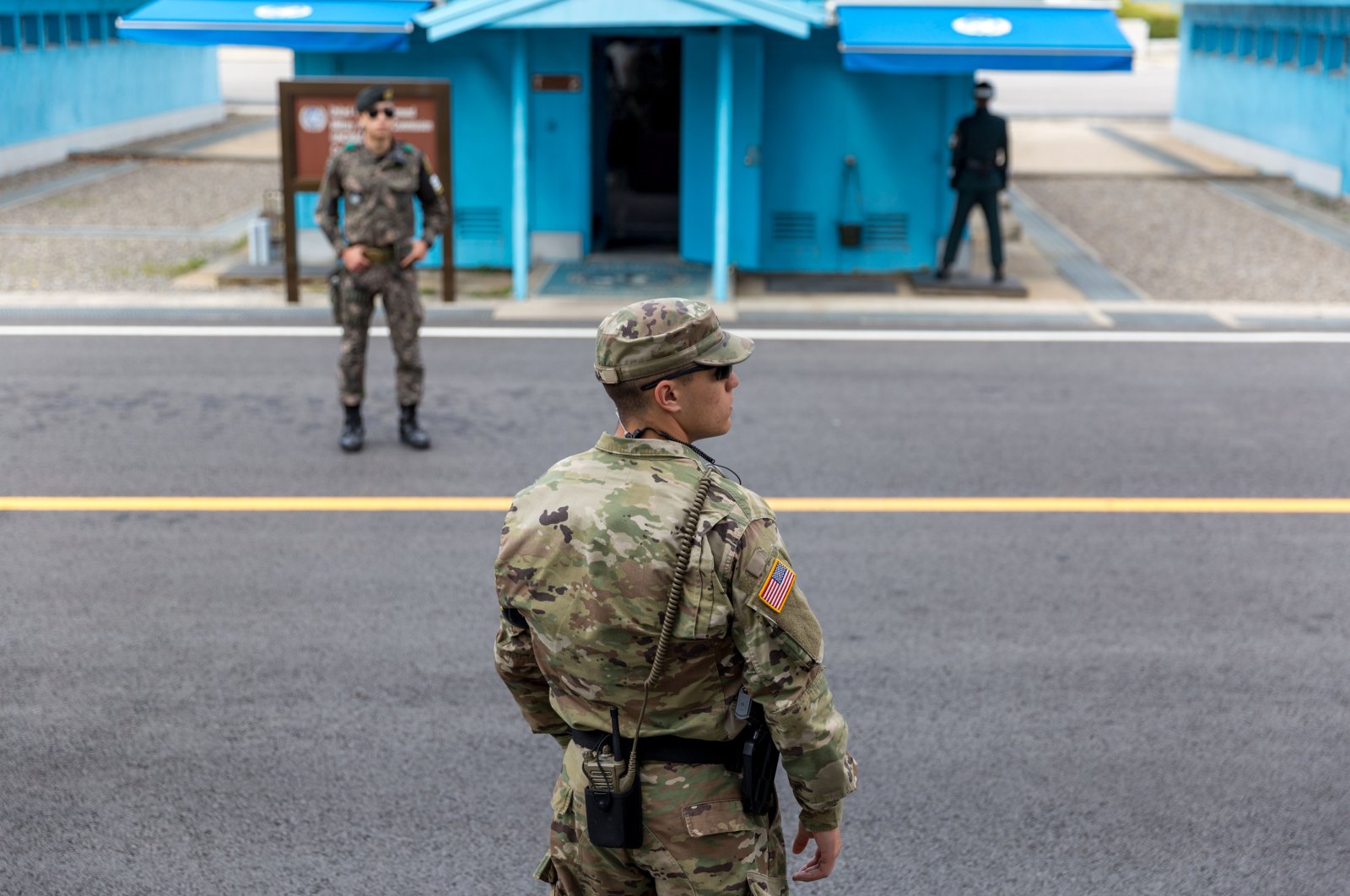 U.S. Marine and two Republic of Korea (ROK) soldiers watching over the demilitarized zone (DMZ) at the Korean border, Joint Security Area, Kaesong, South Korea, April 22, 2017. (Shutterstock Photo)