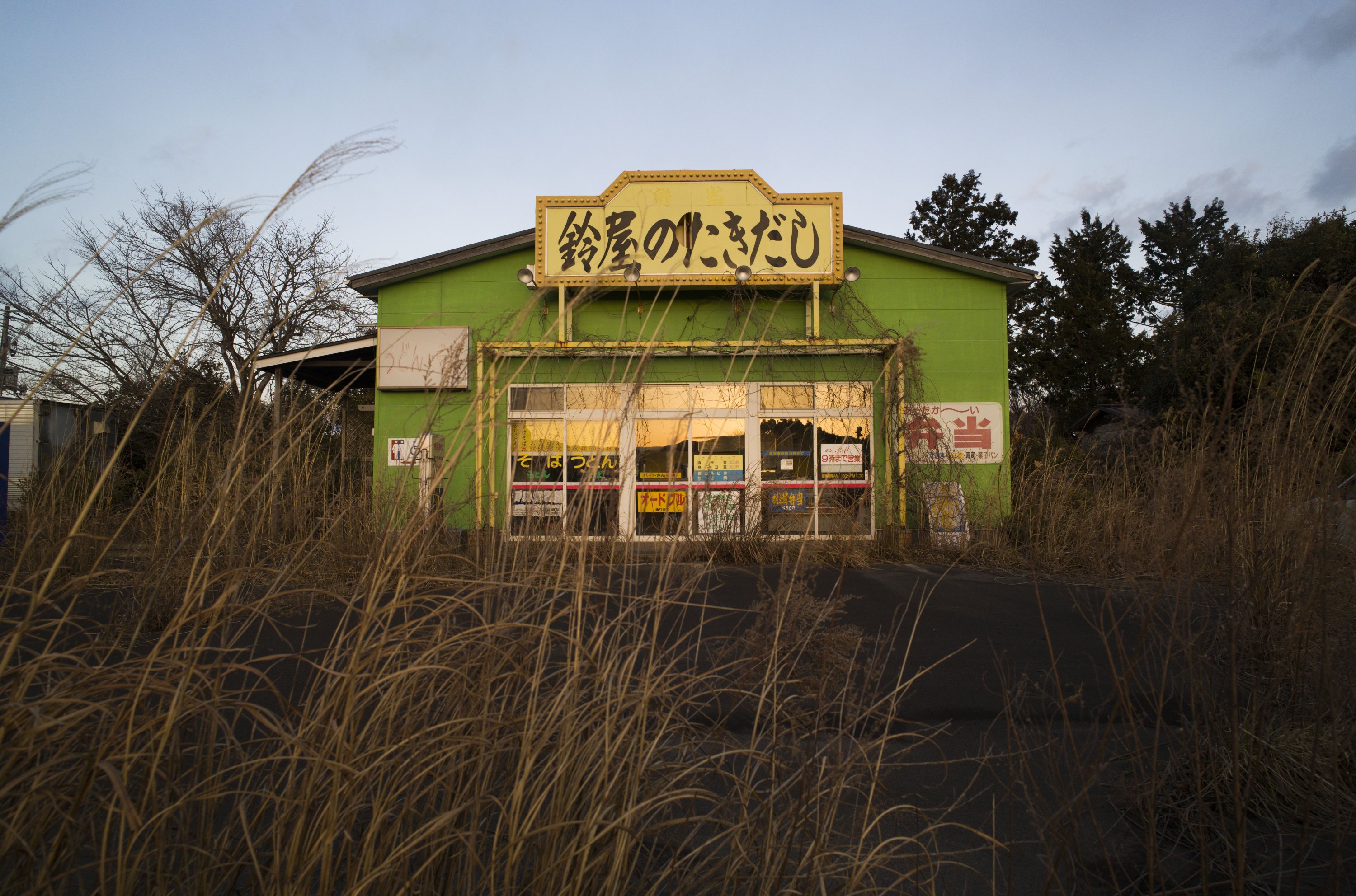 An abandoned restaurant stands surrounded by weeds in the exclusion zone in Tomioka town, Fukushima prefecture, northeastern Japan, Feb. 27, 2021. (AP)