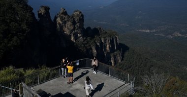 Tourists pose for photos at the Three Sisters rock formation in the Blue Mountains National Park in the wake of regional travel reopening as COVID-19 restrictions are eased, New South Wales, Katoomba, Australia, June 5, 2020.  (Reuters)