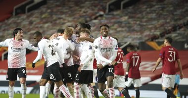 AC Milan players celebrate after Simon Kjaer scored Milan side's opening goal during the Europa League round of 16 first leg football match between Manchester United and AC Milan at Old Trafford in Manchester, England, March 11, 2021. (AP Photo)