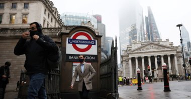 People exit Bank station in the City of London financial district, amid the coronavirus outbreak, in London, Britain, March 4, 2021. (Reuters Photo)