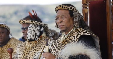 Zulu King Goodwill Zwelithini (R) watches members of a group perform as Zulu warriors and British Soldiers on the 140th-anniversary of the Battle of Isandluana in Dundee, South Africa, Jan. 25, 2019.