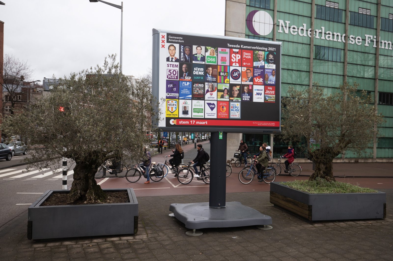Cyclists at a road crossing near Dutch political party election campaign posters on a billboard in Amsterdam, Netherlands, on Tuesday, March 9, 2021. (Getty Images)