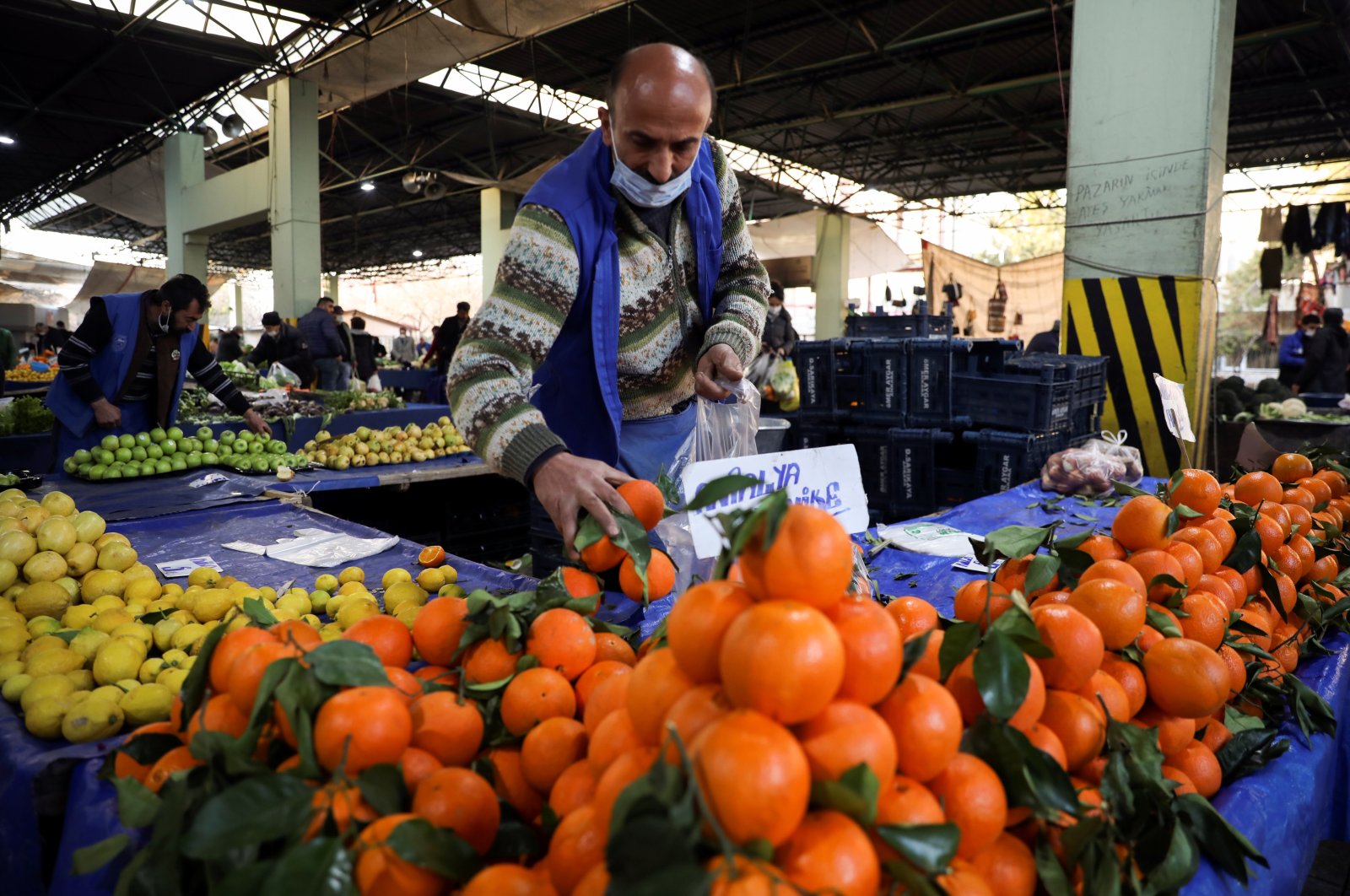 A vendor wearing a protective mask arranges fruit on his stall at a local market, amid the coronavirus disease (COVID-19) outbreak in Ankara, Feb. 24, 2021. (Reuters Photo)