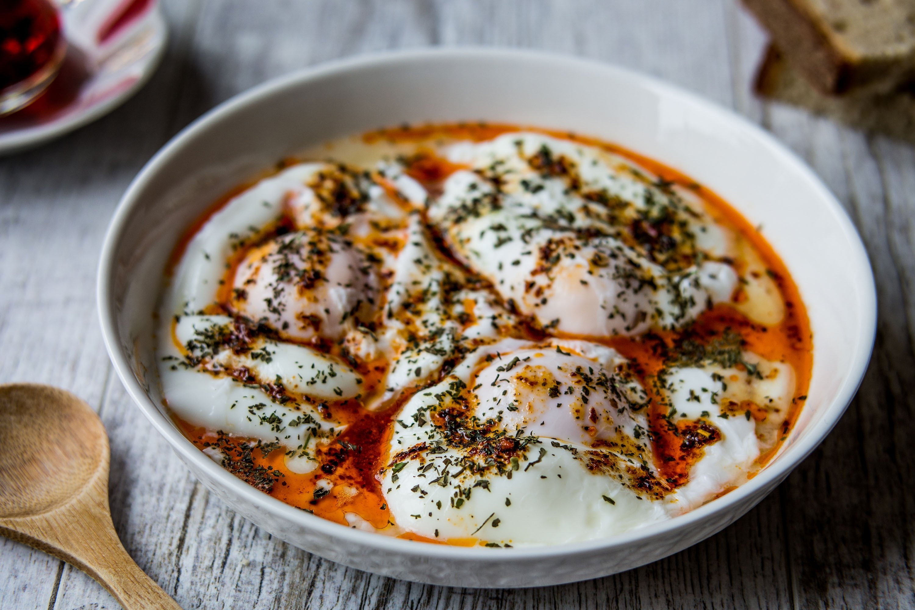 Çılbır is made of poached eggs doused in yogurt and topped off with spicy melted butter. (Shutterstock Photo)