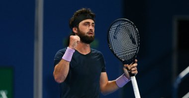 Georgia's Nikoloz Basilashvili celebrates during his match with Roger Federer at the Qatar ExxonMobil Open at the Khalifa International Tennis and Squash Complex, Doha, Qatar, March 11, 2021. (AFP Photo)