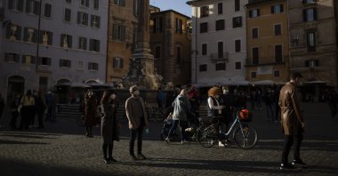 People spend their time outdoors amid the coronavirus spread, central Rome, Italy, March 13, 2021. (Photo by Getty Images)
