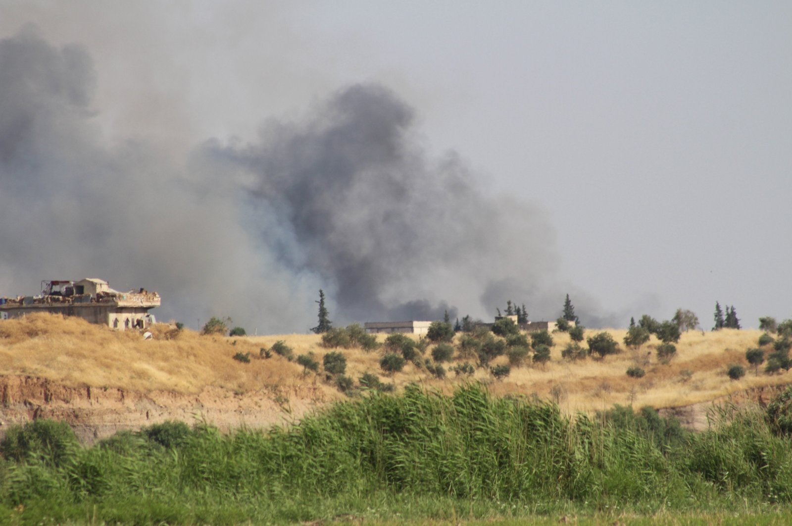 Smoke is seen in a village east of Syria's Jarablus on June 26, 2019 (AA File Photo)